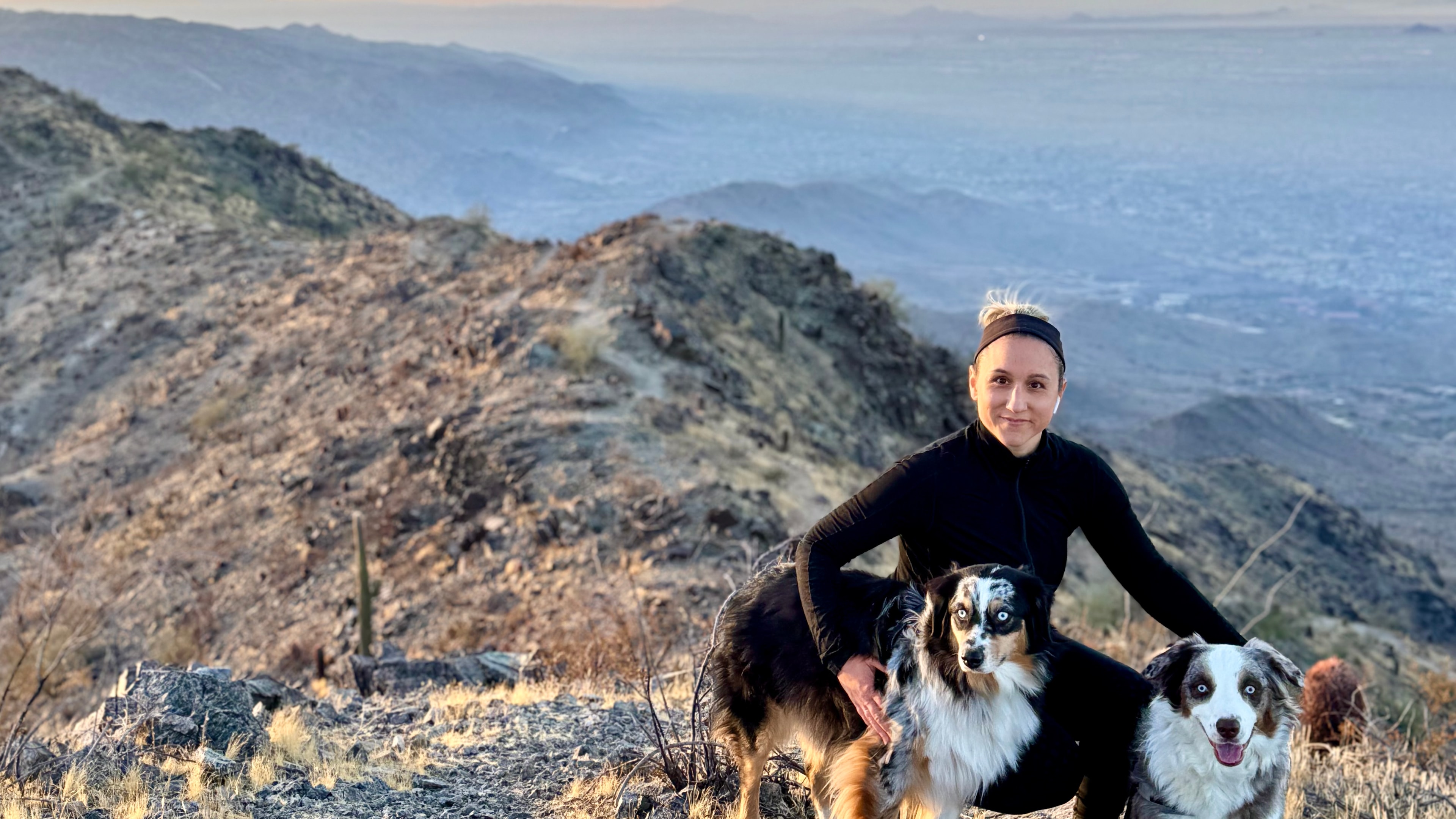 Sara Lenz with her Australian Shepherds Sonia and Ruth on a mountain trail